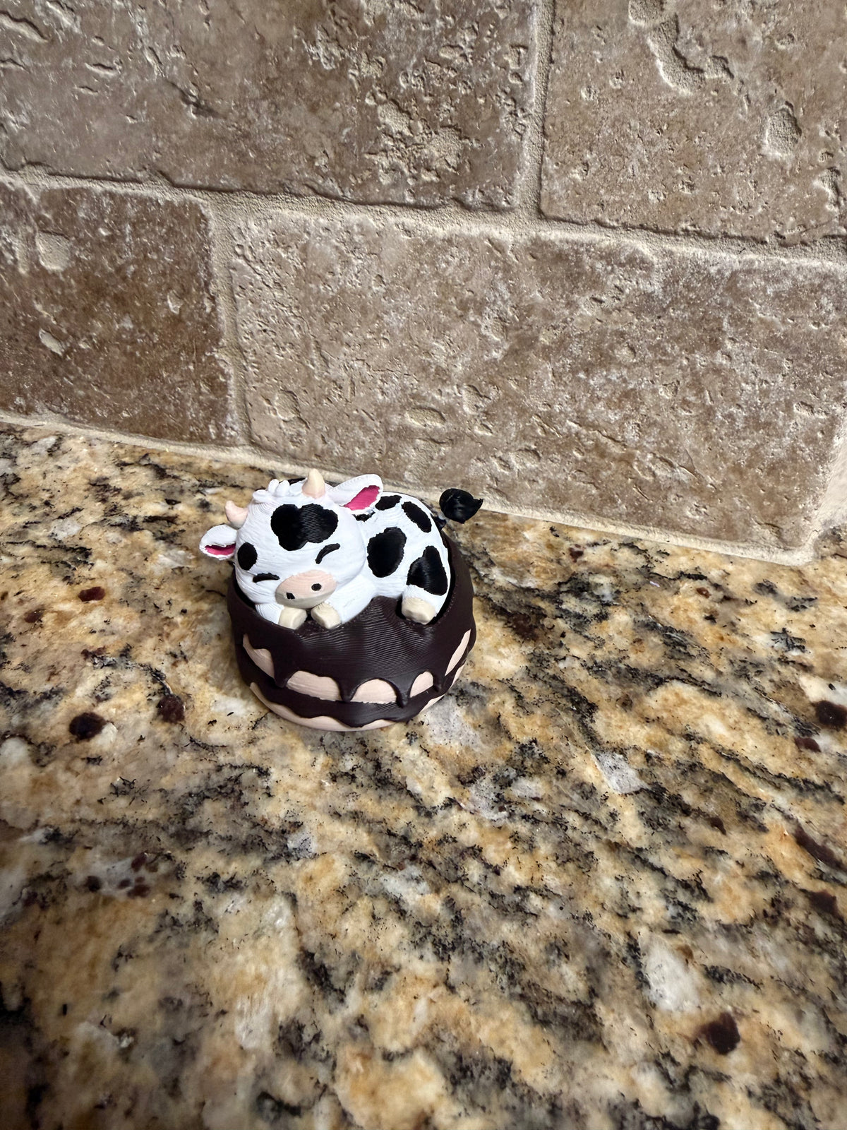 Sleeping dairy cow on a donut clicker