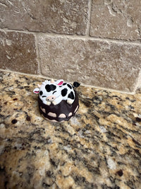 Sleeping dairy cow on a donut clicker