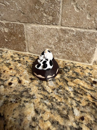 Sleeping dairy cow on a donut clicker