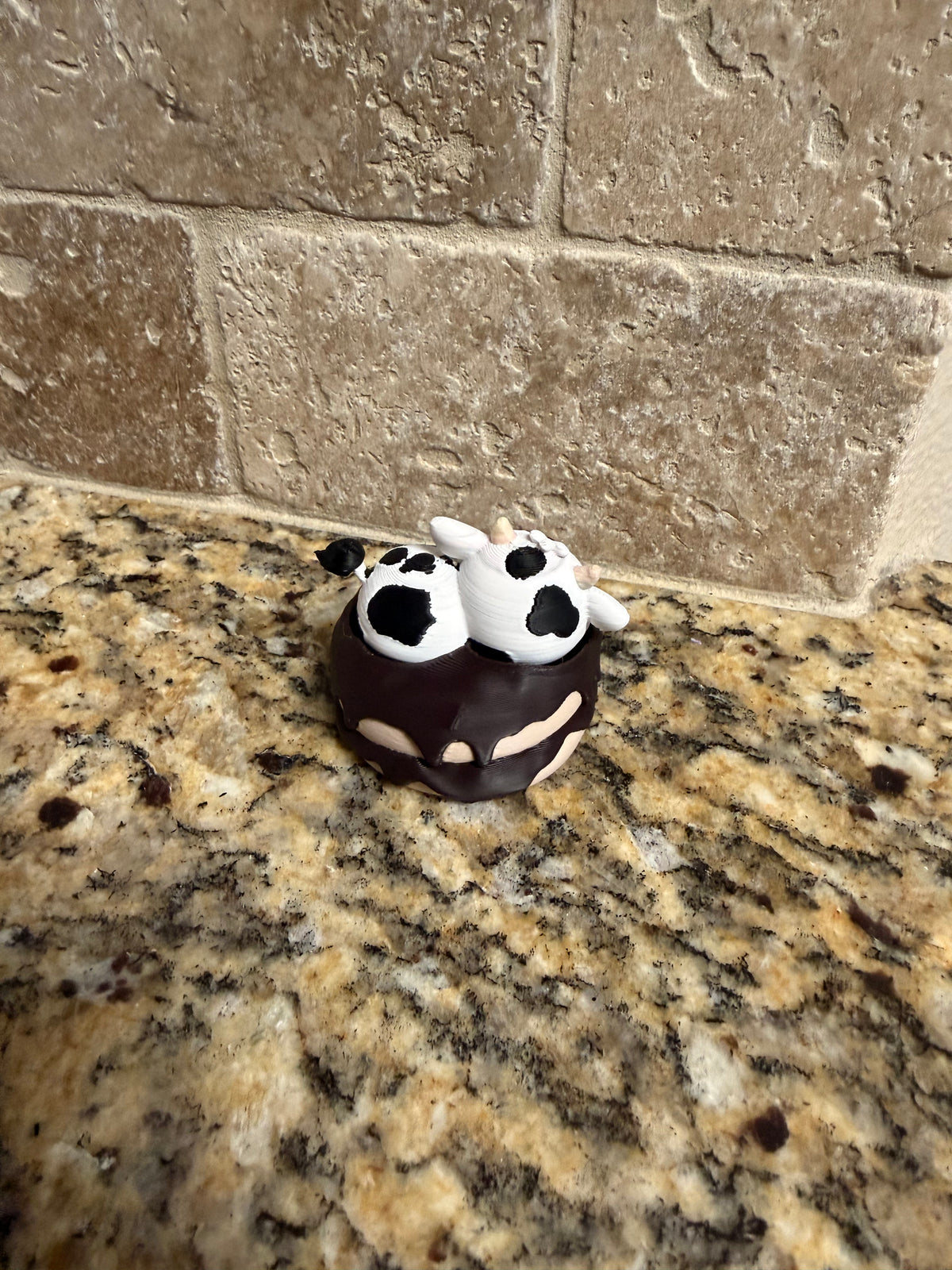 Sleeping dairy cow on a donut clicker