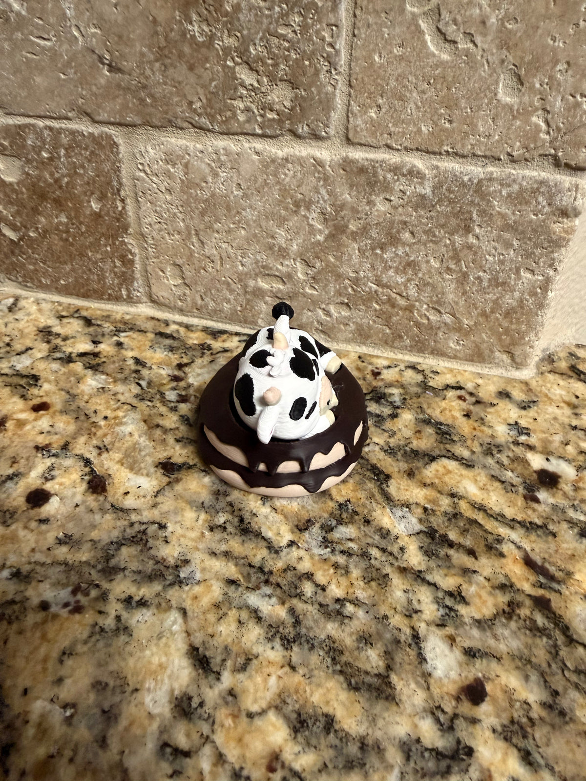 Sleeping dairy cow on a donut clicker